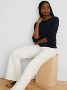 Navy blue long-sleeve boat neck tee with a smooth knit texture.