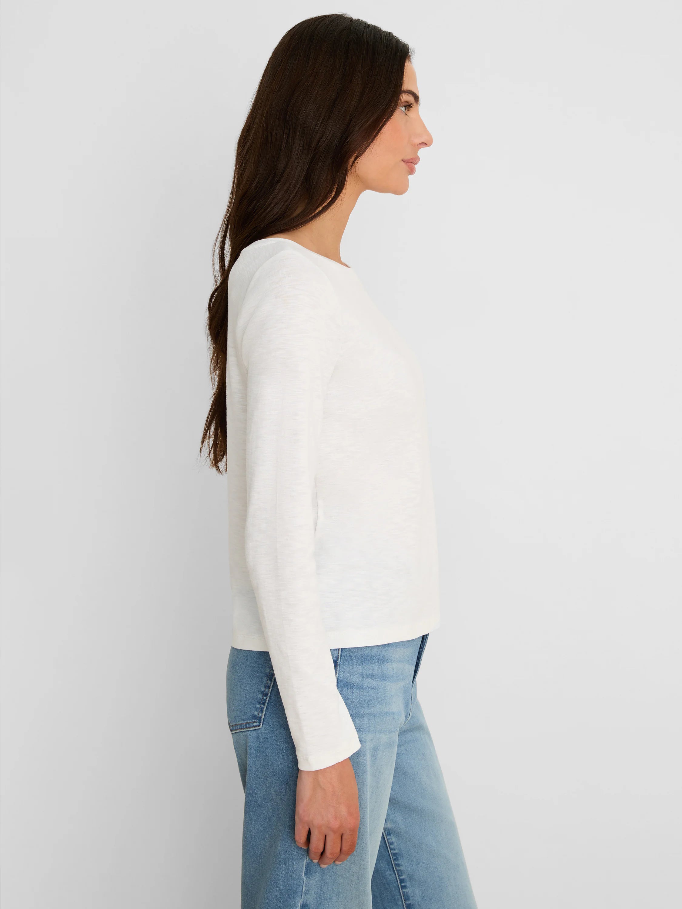 White solid ribbed long-sleeve boat neck tee worn by a model.