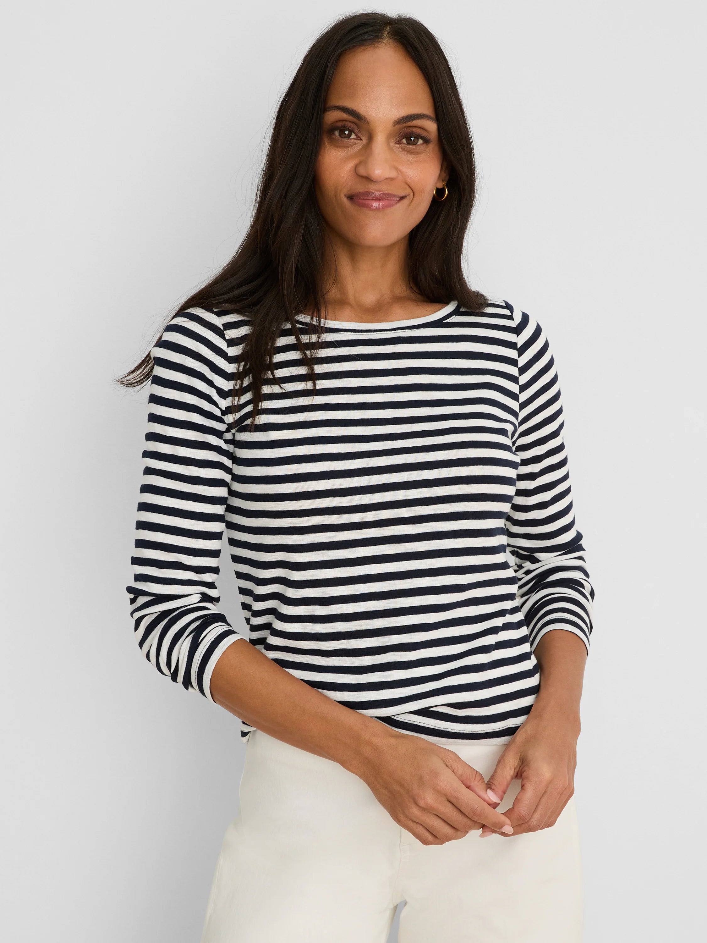 Navy and off-white horizontal stripe boat neck long sleeve tee.