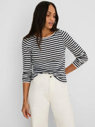 Navy and white horizontal stripe long-sleeve boat neck tee.