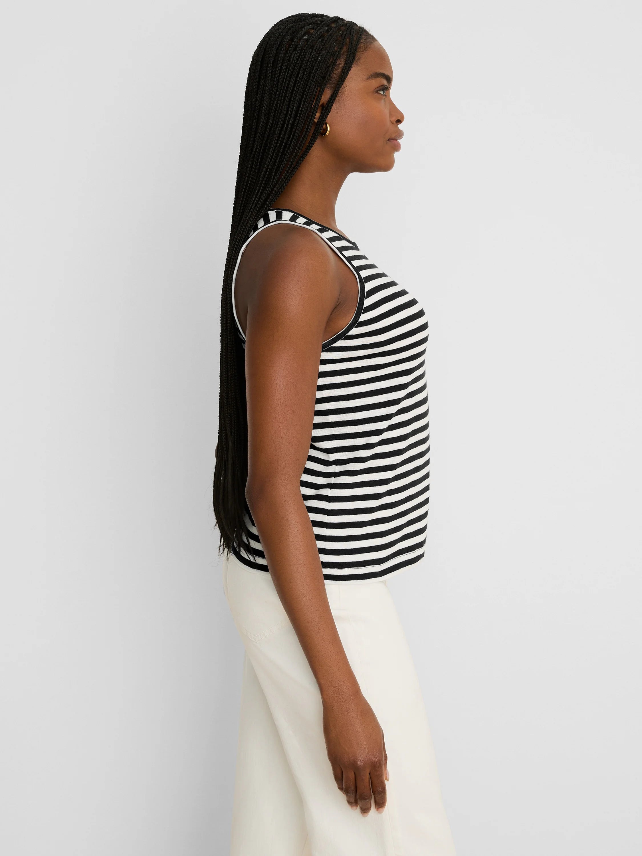 Black and white striped tank top with white trim at the neck and armholes.