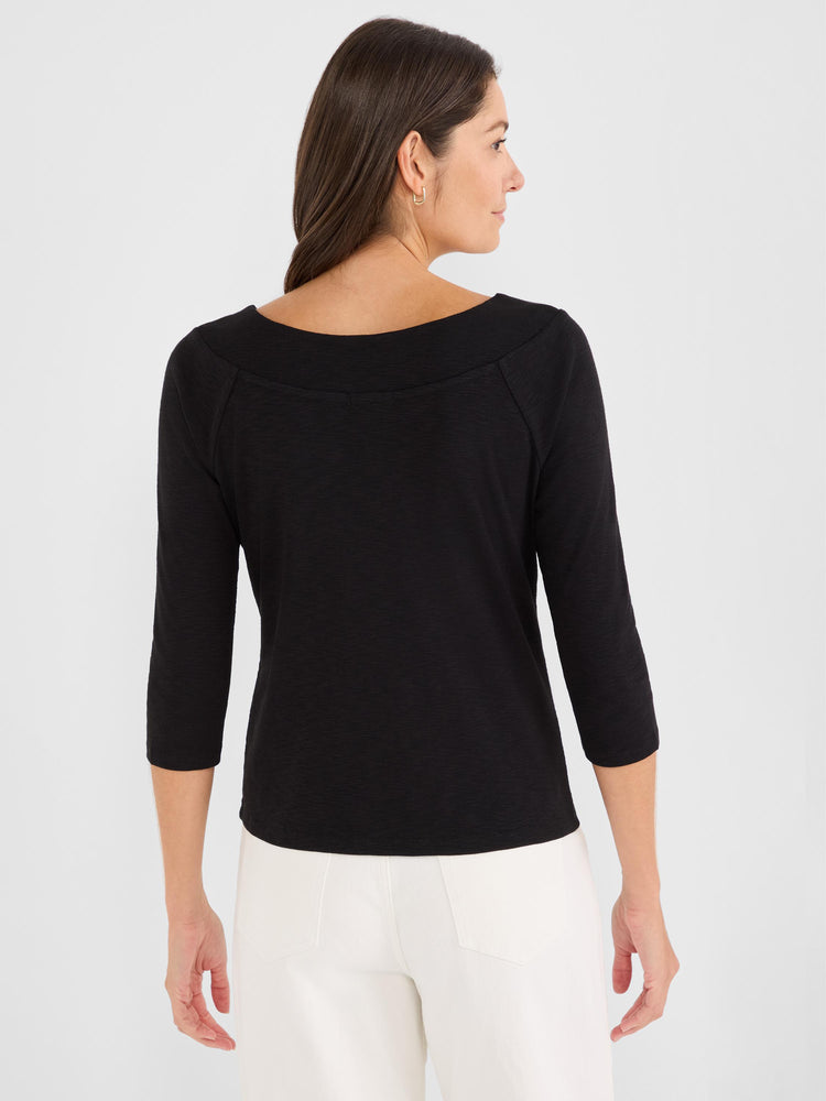 Casual black three-quarter sleeve top features a wide boat neck and a subtle slub knit texture.