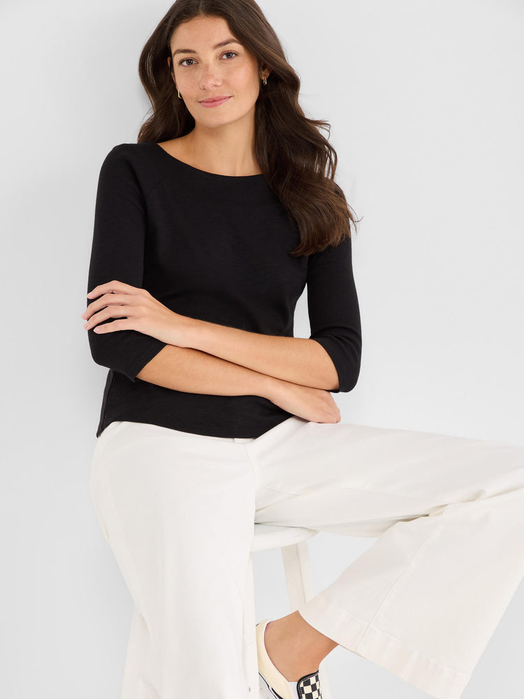 Black fitted top with a boat neckline and three-quarter length raglan sleeves.