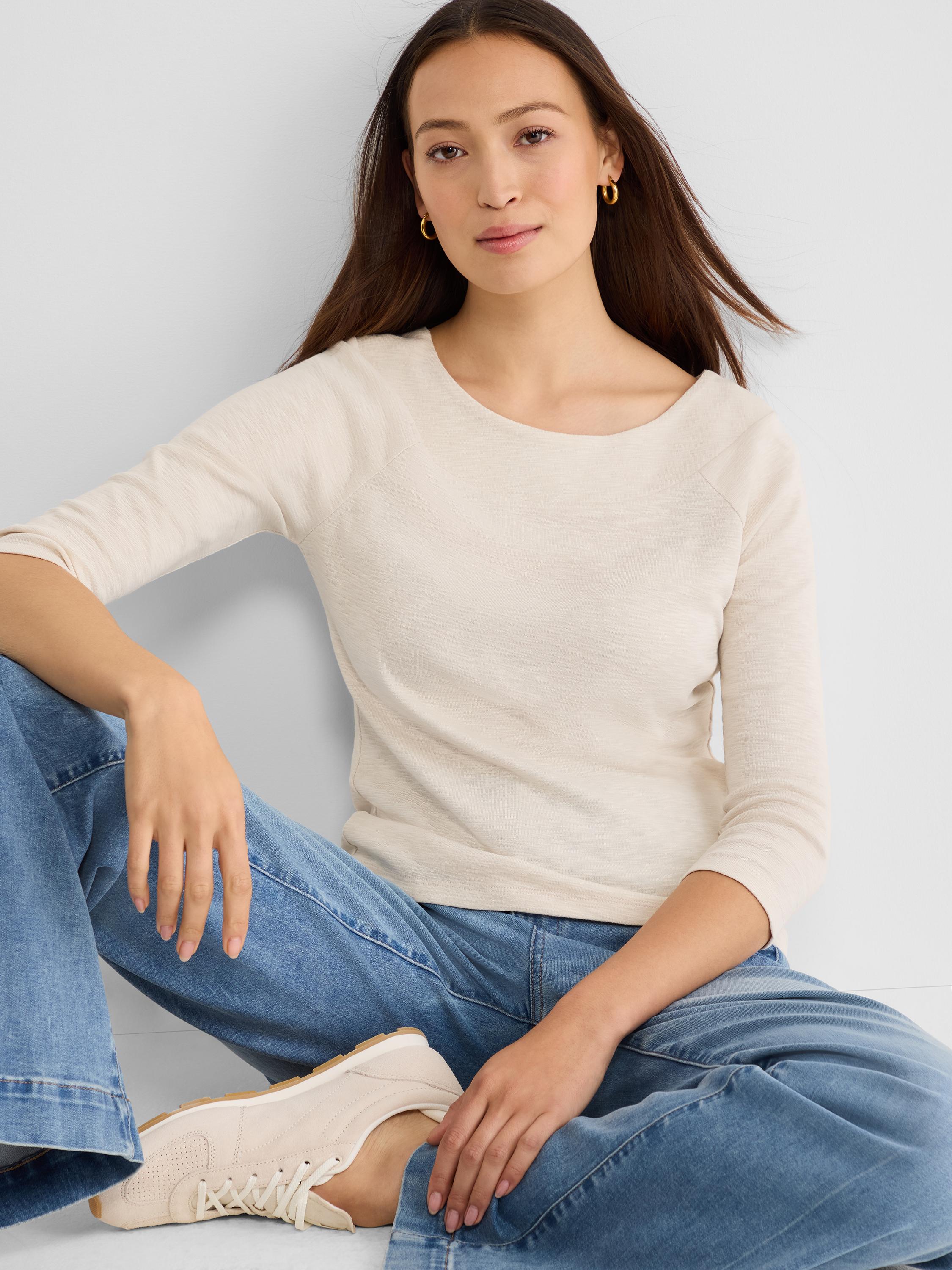 A fitted cream heathered knit top with a scoop neck and three-quarter raglan sleeves.