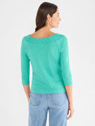 The fitted teal heathered knit top features three-quarter sleeves and an elegant, wide boat neckline.