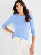 A fitted, light blue heathered knit top featuring three-quarter raglan sleeves and a wide boat neckline.