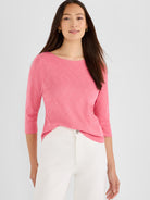 Pink heathered knit top with a boat neck and three-quarter sleeves, styled in a relaxed fit.