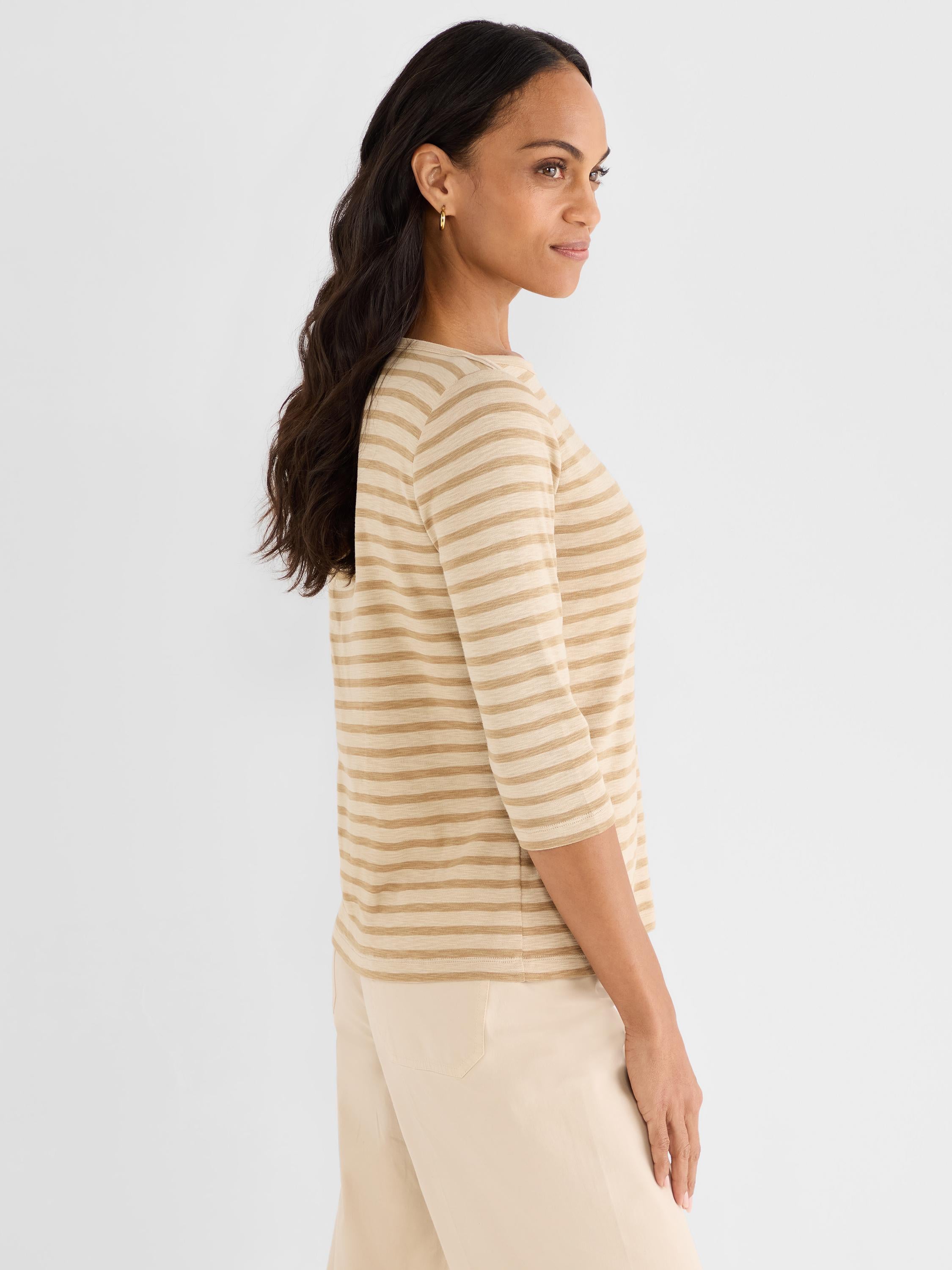 Model wears a regular-fit, tan and beige striped knit top featuring a boat neck and three-quarter length sleeves.