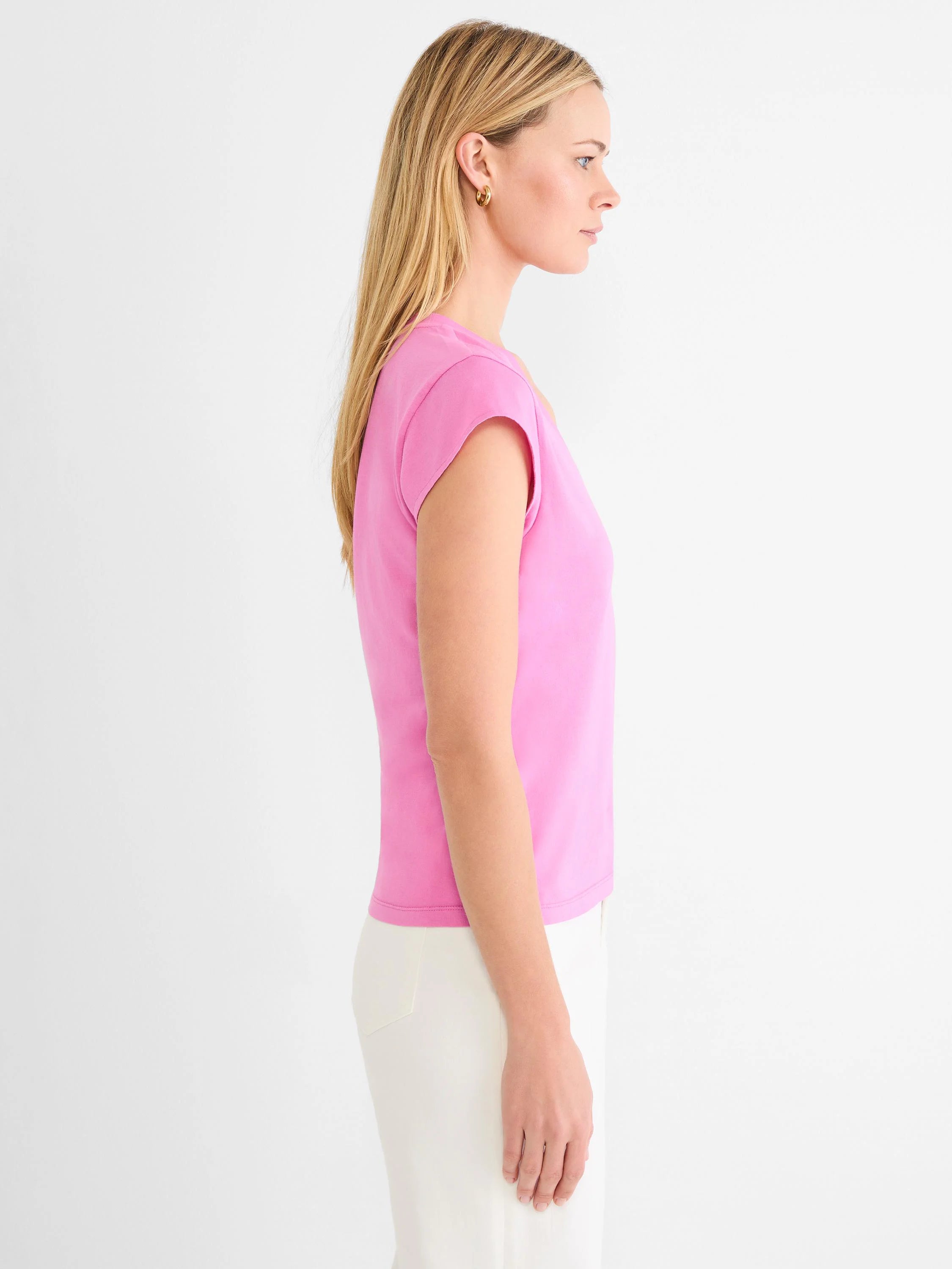 Pink cap sleeve V-neck tee, shown from the side on a model.