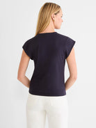 Navy cap sleeve tee, back view on model. Features a round neckline.