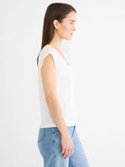 White cap sleeve V-neck tee on model, side view, relaxed fit.