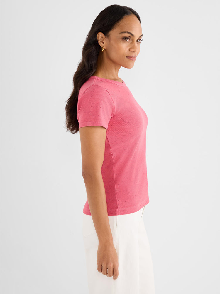The model wears a fitted pink heathered ribbed knit tee shirt with short sleeves and a crew neck.