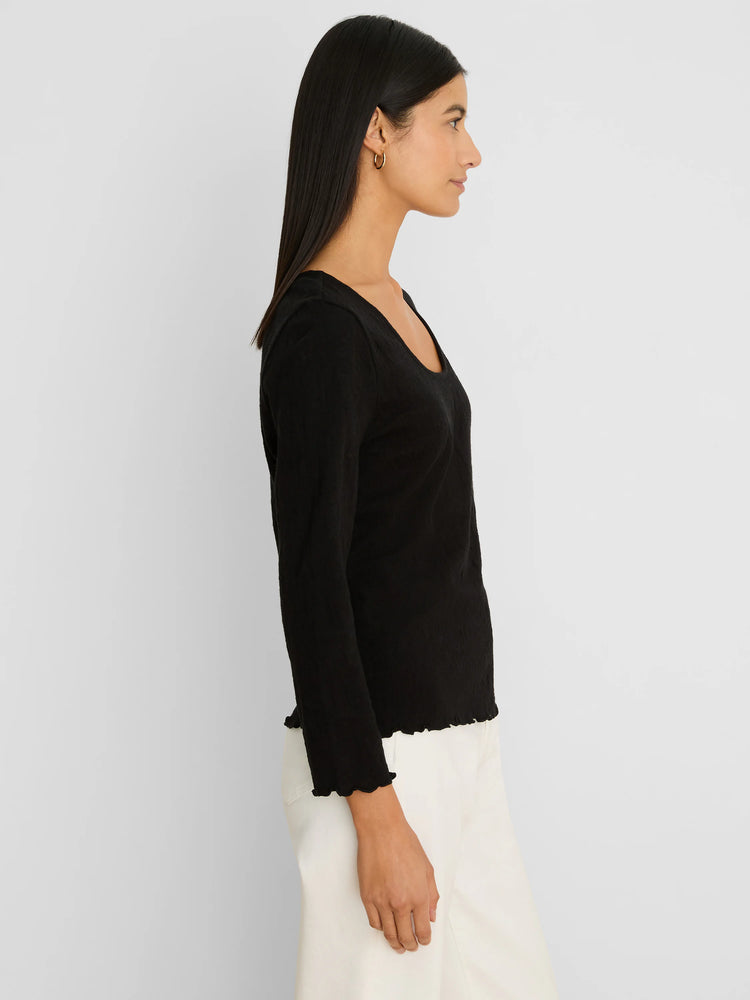 Black 3/4 sleeve lace knit scoop neck tee with ruffled cuffs and hem.