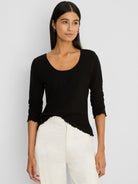 Black 3/4 sleeve knit scoop tee with ruffled trim on cuffs and bottom hem.
