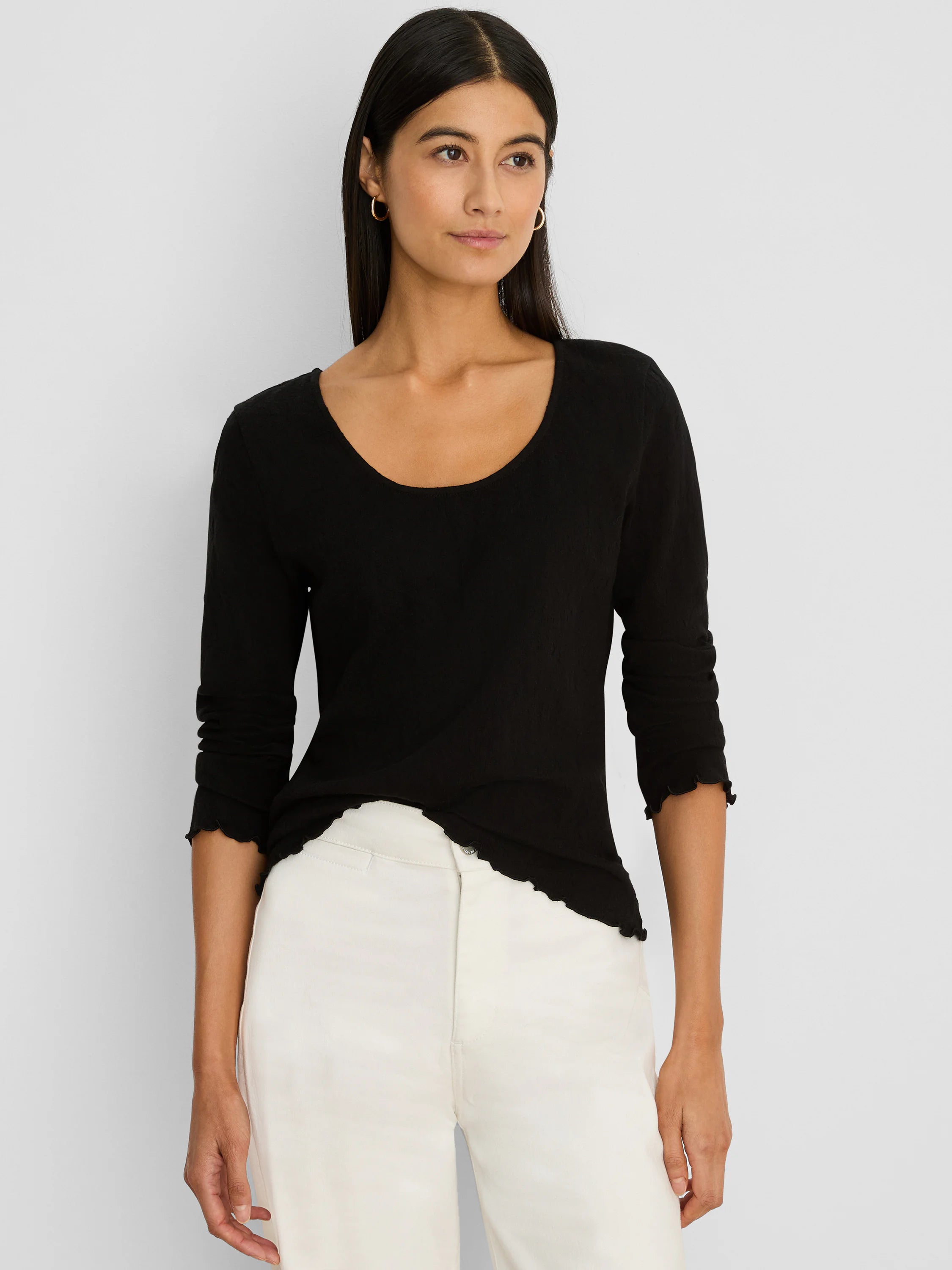 Black 3/4 sleeve knit scoop tee with ruffled trim on cuffs and bottom hem.