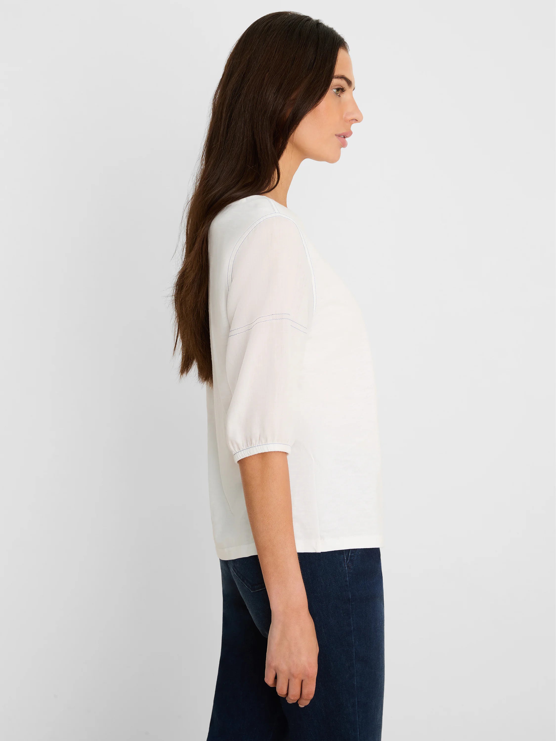 Off-white round neck tee with 3/4 linen sleeves, gathered cuffs, and blue accent stitching on shoulder and sleeve seams.