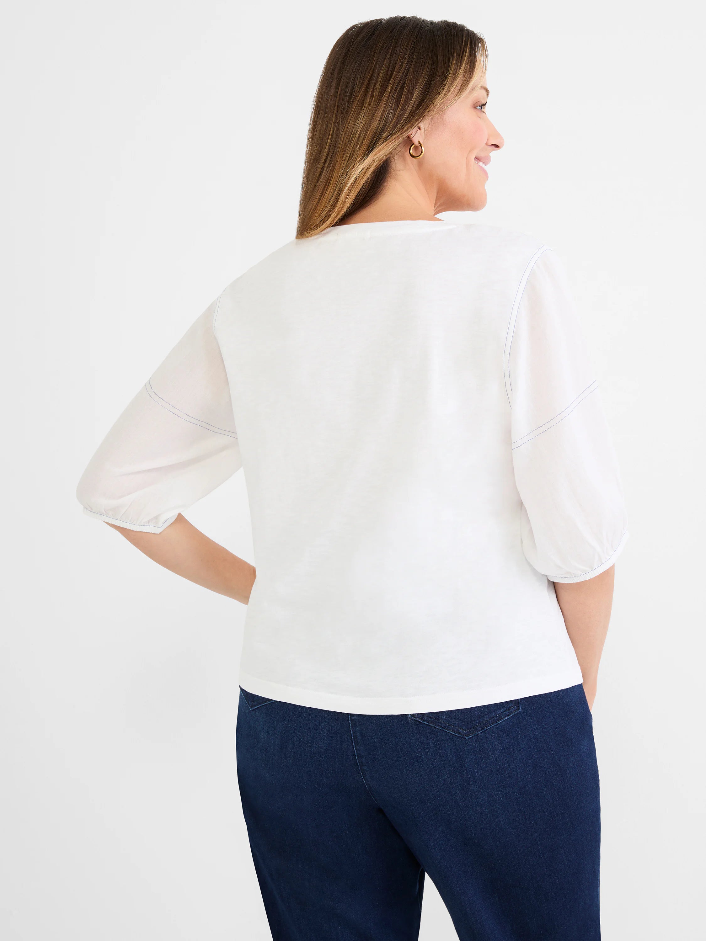 White cotton tee with semi-sheer linen 3/4 sleeves featuring visible blue contrast stitching.