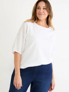 White cotton tee with wide neck, elbow-length linen sleeves, and subtle blue stitching.