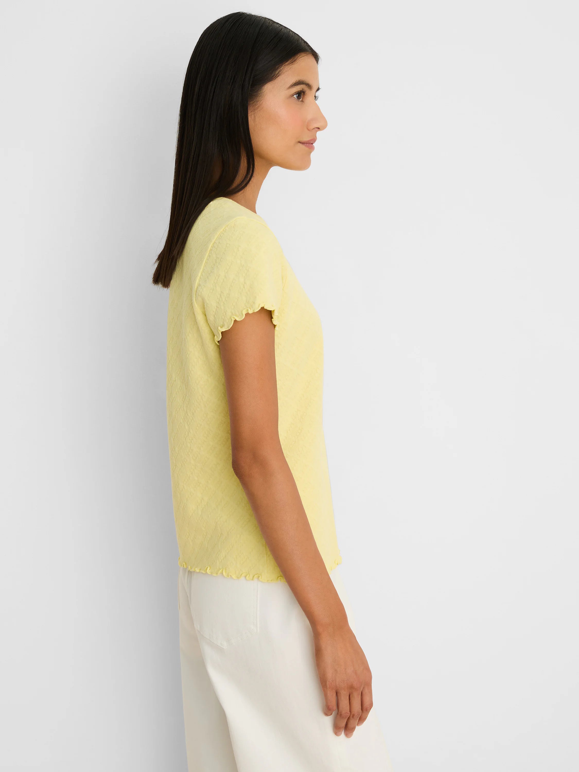 Pale yellow lace knit t-shirt with short ruffled sleeves and hem.