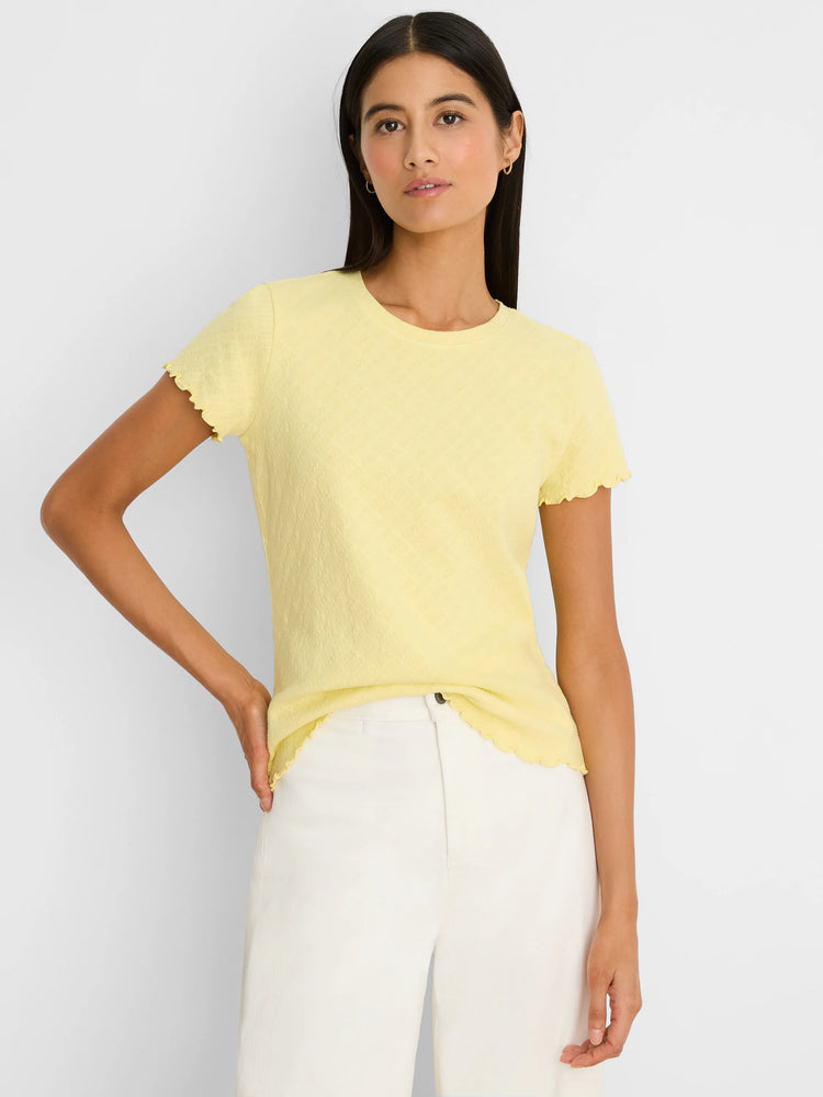 Pale yellow lace knit t-shirt with a subtle pattern, crew neck, and scalloped sleeves and hem.
