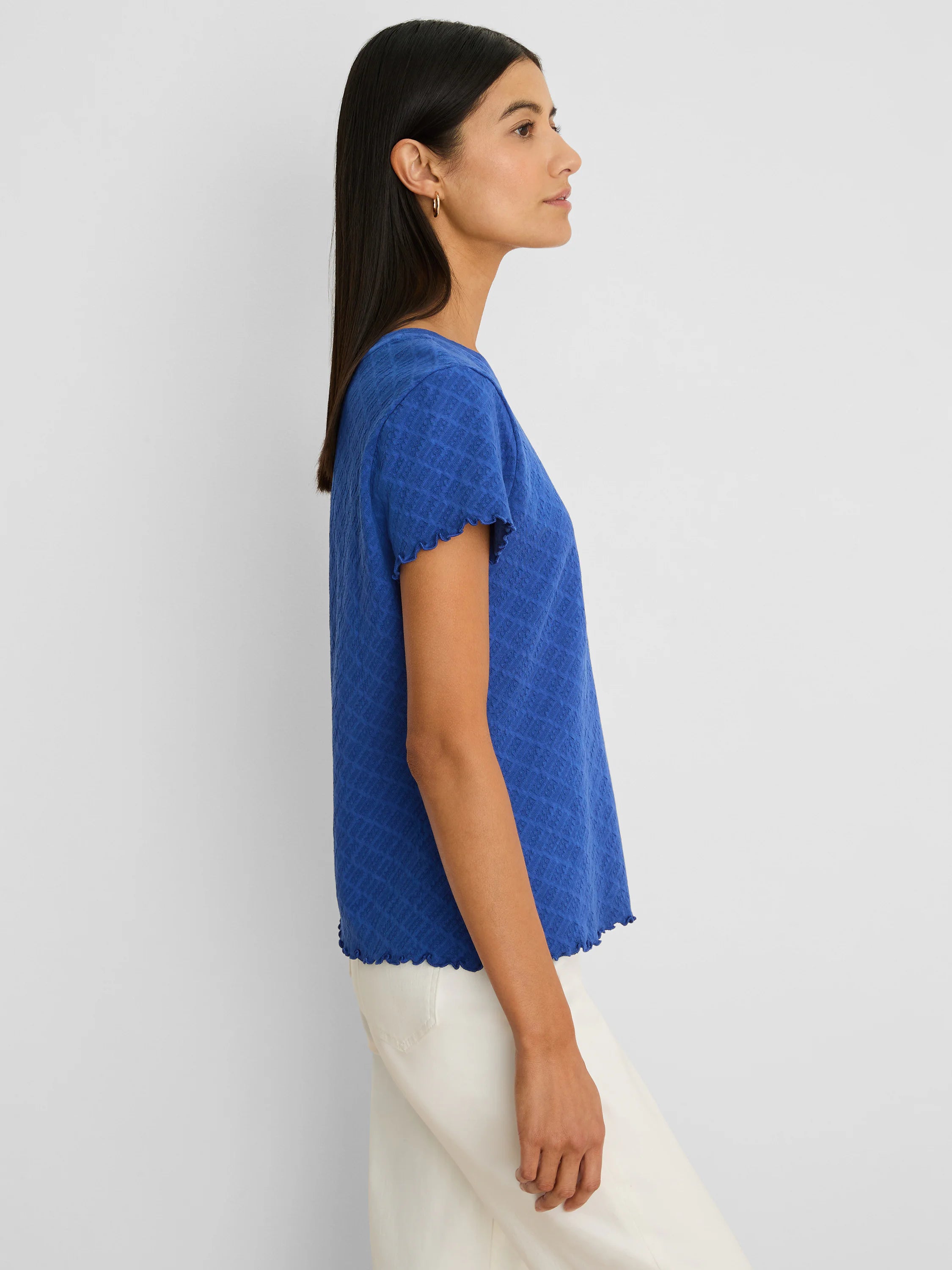 Vibrant blue lace knit t-shirt with short sleeves and scalloped trim on the sleeves and hem.