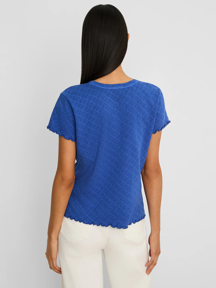 Blue T-shirt with a lace knit diamond pattern, short sleeves, and ruffled trim on the neckline, sleeves, and hem.