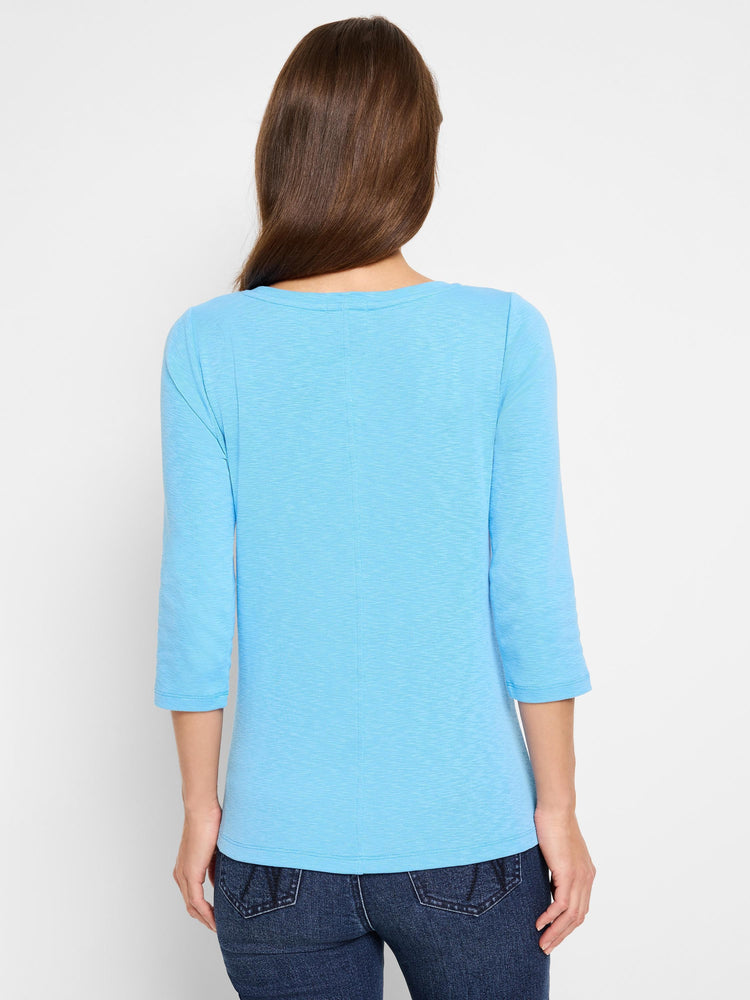 Light blue 3/4 sleeve boat neck tee with textured fabric, shown from the back on a model.