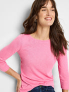 Bright pink, heathered 3/4 sleeve boat neck tee on a model. Shows fabric texture and garment fit.