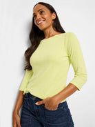 Pale lime green 3/4 sleeve boat neck tee with a subtle textured knit fabric.