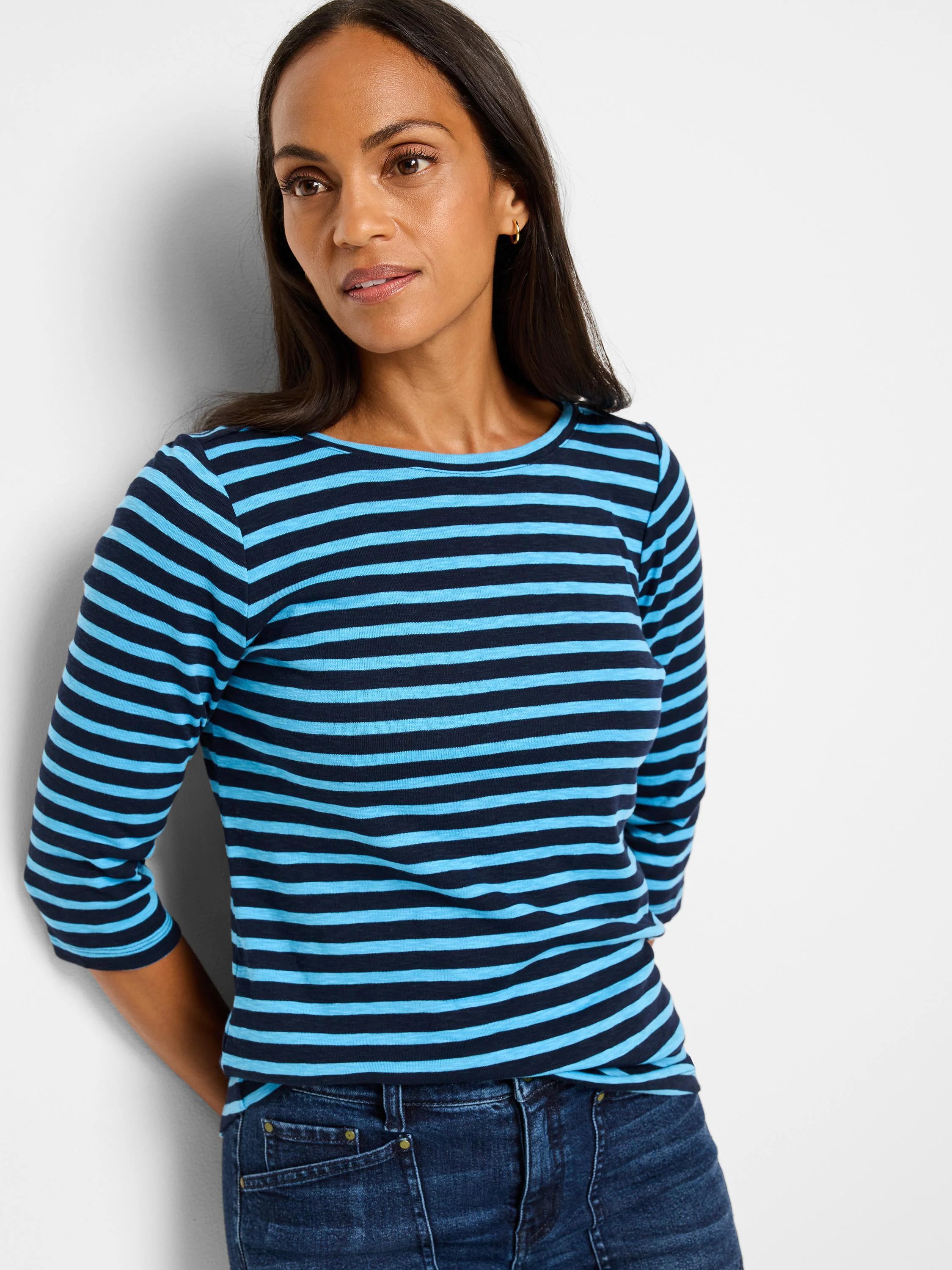 Navy and cerulean horizontally striped 3/4 sleeve boat neck tee.