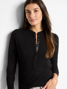 Black long-sleeve henley shirt with a placket of dark buttons.  Three-quarter sleeves.
