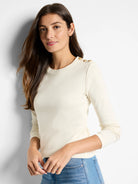 Off-white long-sleeve shirt with three gold buttons on the shoulder.