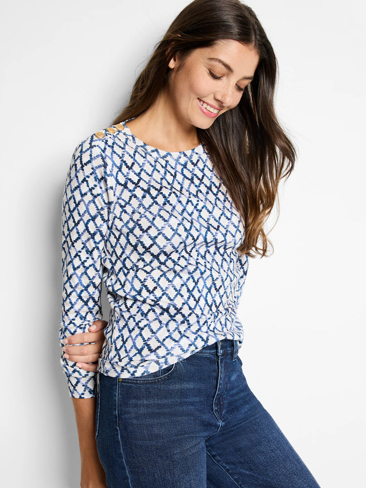 White top with blue diamond pattern, 3/4 sleeves, gold buttons on shoulders.