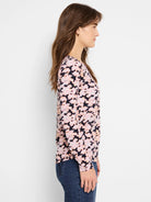 Crew neck, long-sleeve tee.  Pink and black abstract print on dark background.