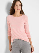 Light pink long-sleeve boat neck tee with thin light gray horizontal stripes.