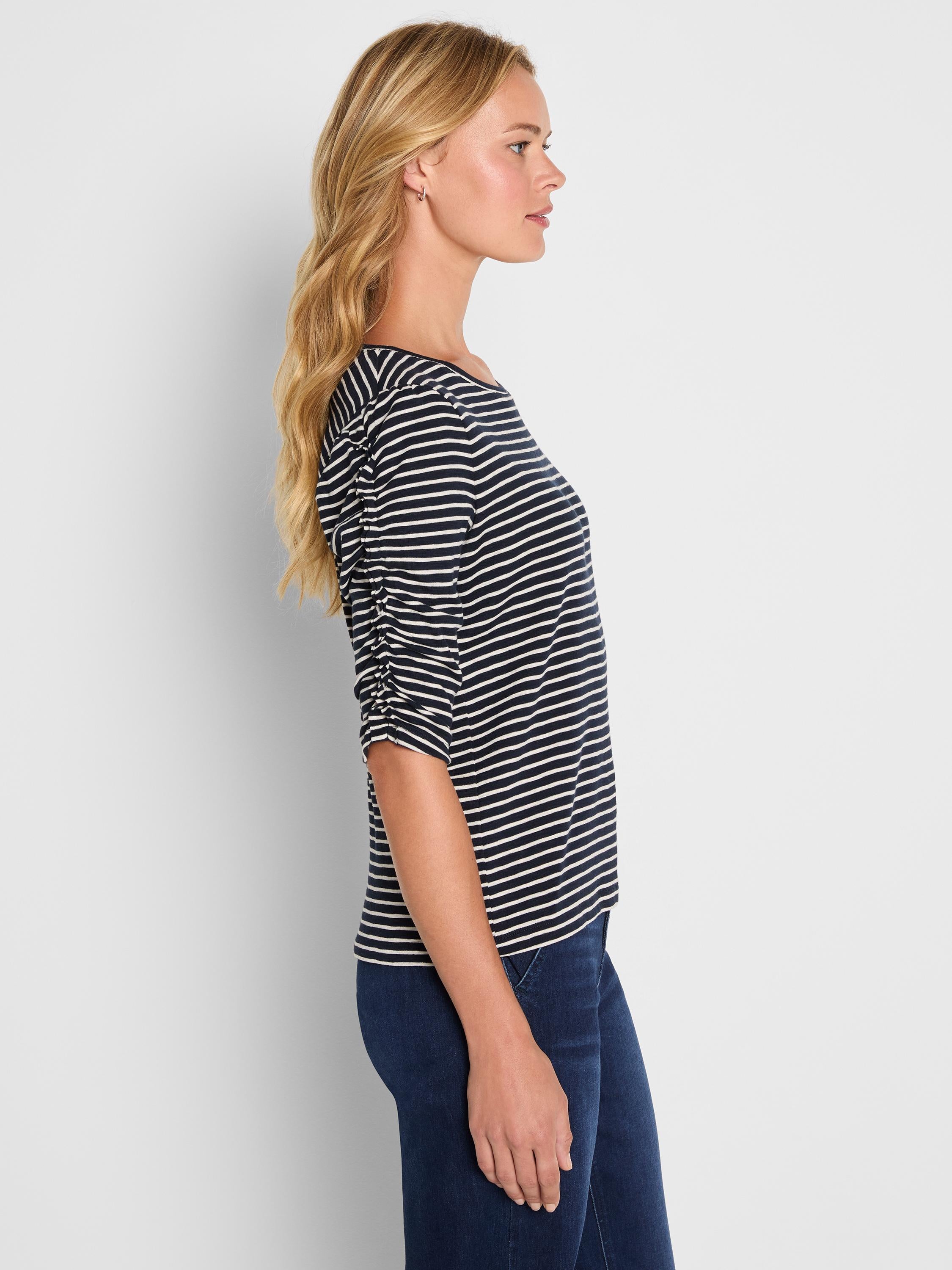 A relaxed navy striped knit top featuring a boat neckline and three-quarter sleeves with ruching details.