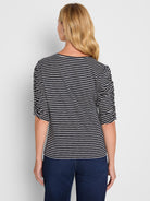 Navy and white striped knit tee featuring ruched three-quarter sleeves and a relaxed fit.