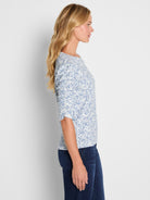 A blue and white patterned knit top with a crew neckline features ruched elbow sleeves and a standard fit.