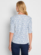 Fitted blue and white abstract print top with three-quarter length gathered sleeves.