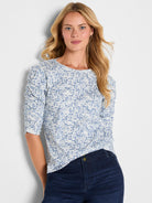 Blue and white abstract print knit top with a scoop neck and ruched three-quarter sleeves.