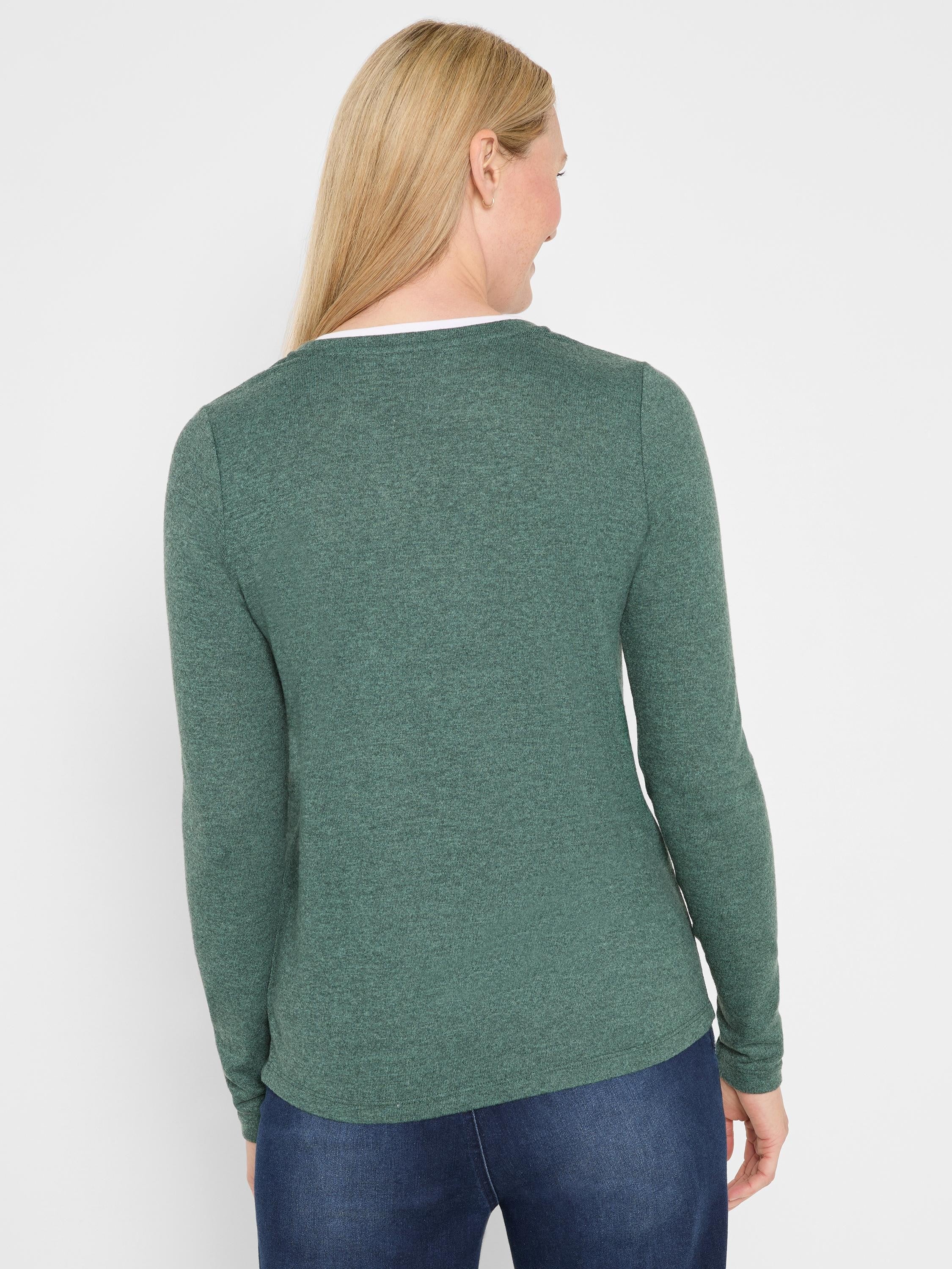 Dark heathered green long sleeve tee worn by a model, showing a white double layer visible at the back of the neckline.