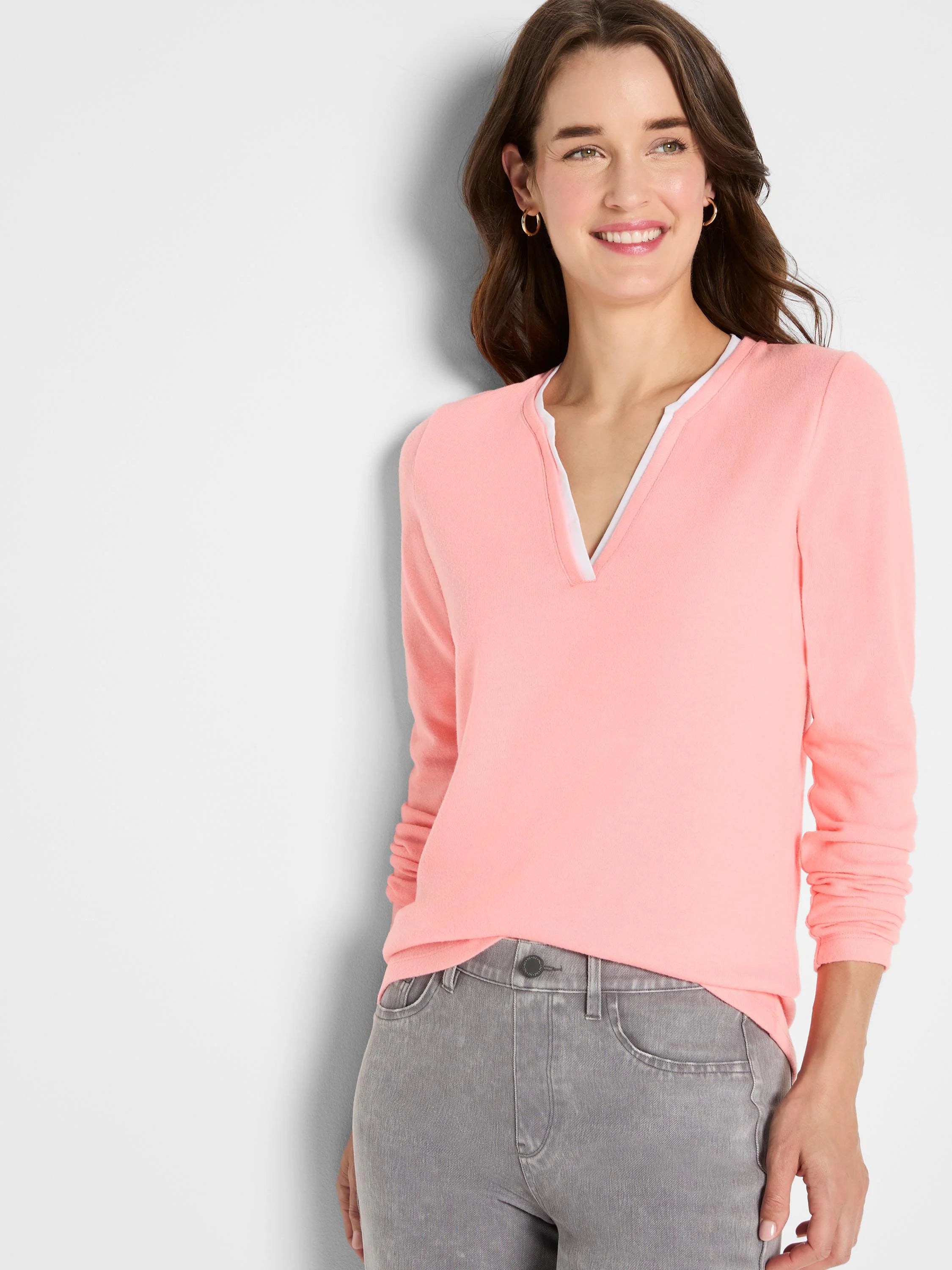 Peach long-sleeve tee with a white double-layer split V-neck.