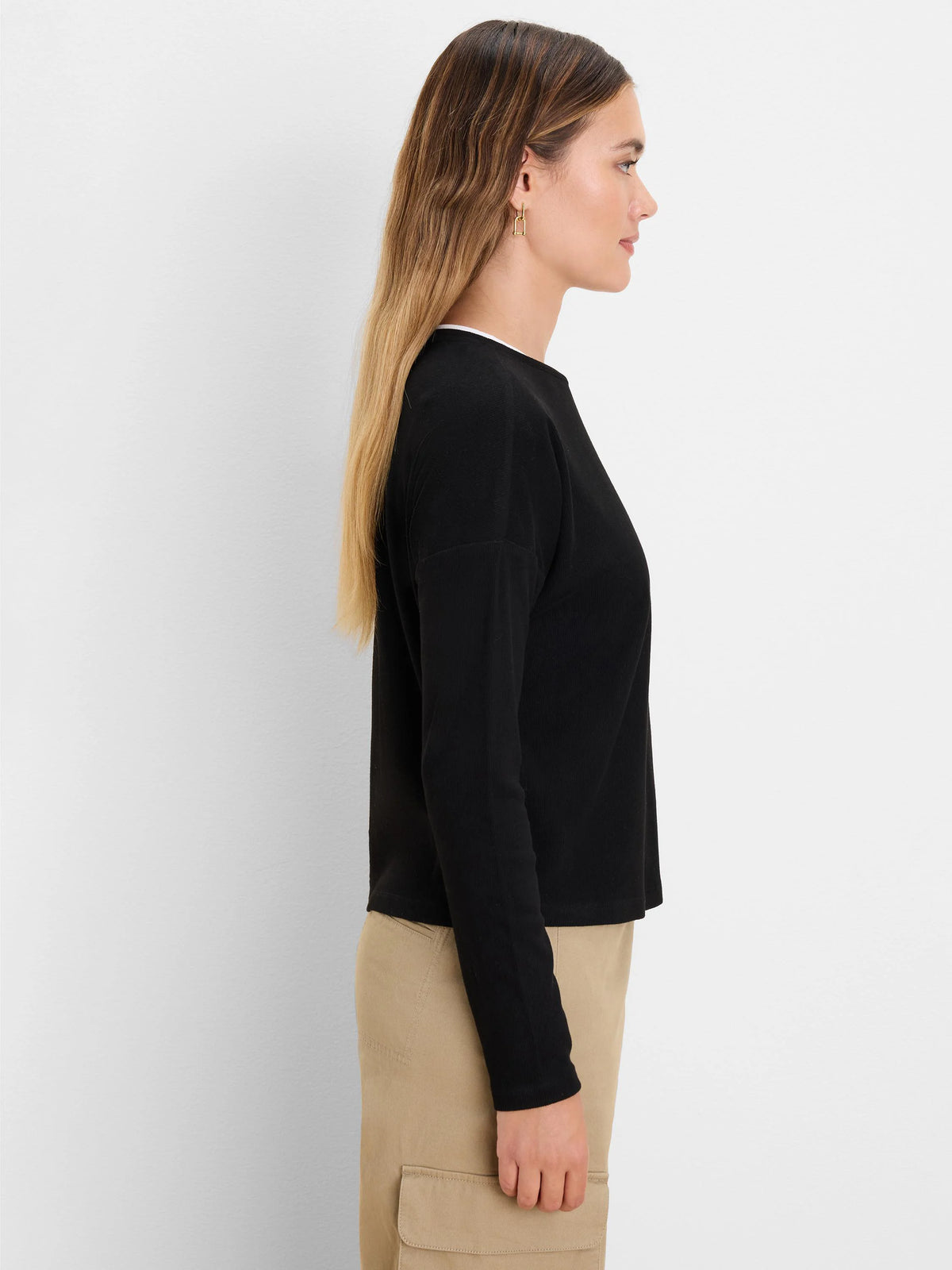 Black ribbed long-sleeve top with white trim at the neck. Double layer design.