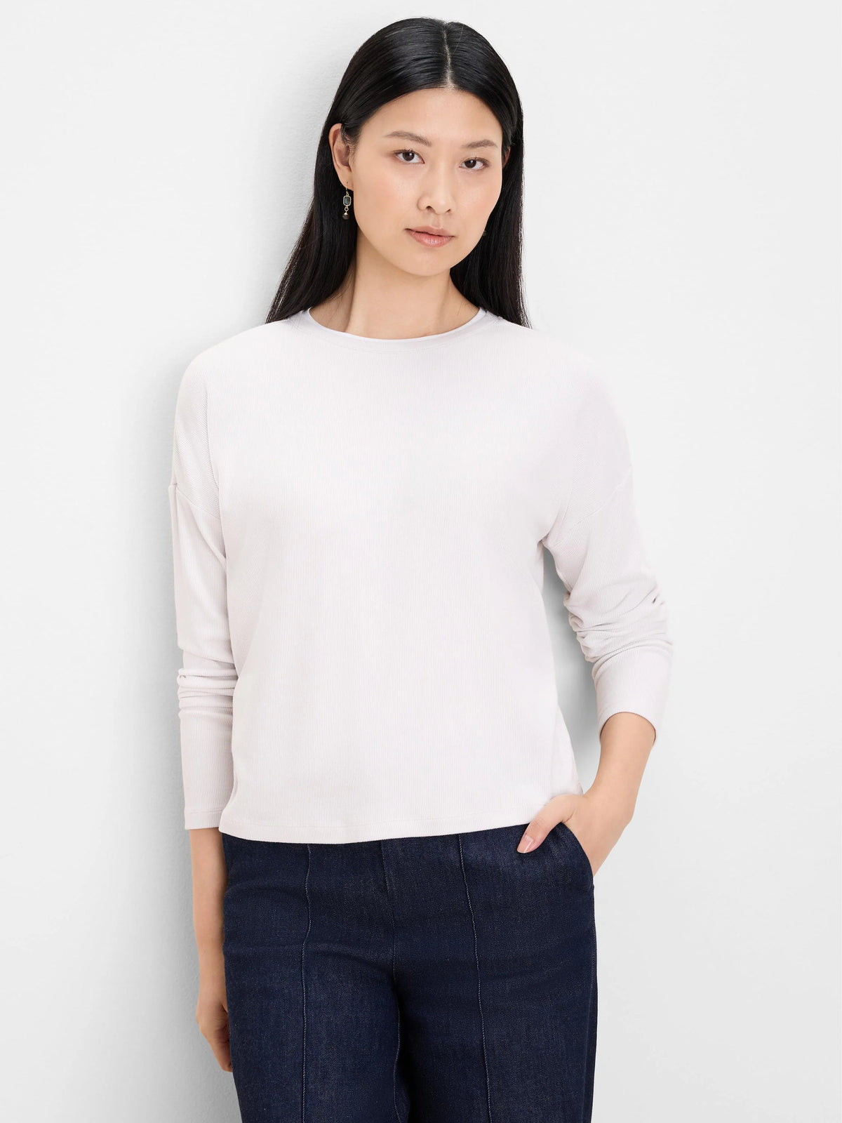 Off-white ribbed long-sleeve top with round neck.