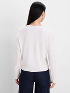 Back view of a light cream, long-sleeved, ribbed double-layer top on a model.