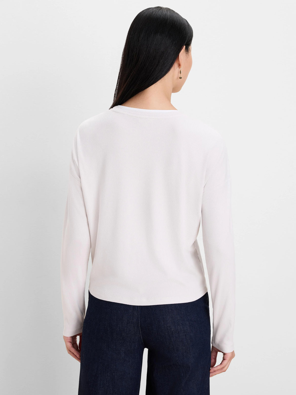 Back view of a light cream, long-sleeved, ribbed double-layer top on a model.