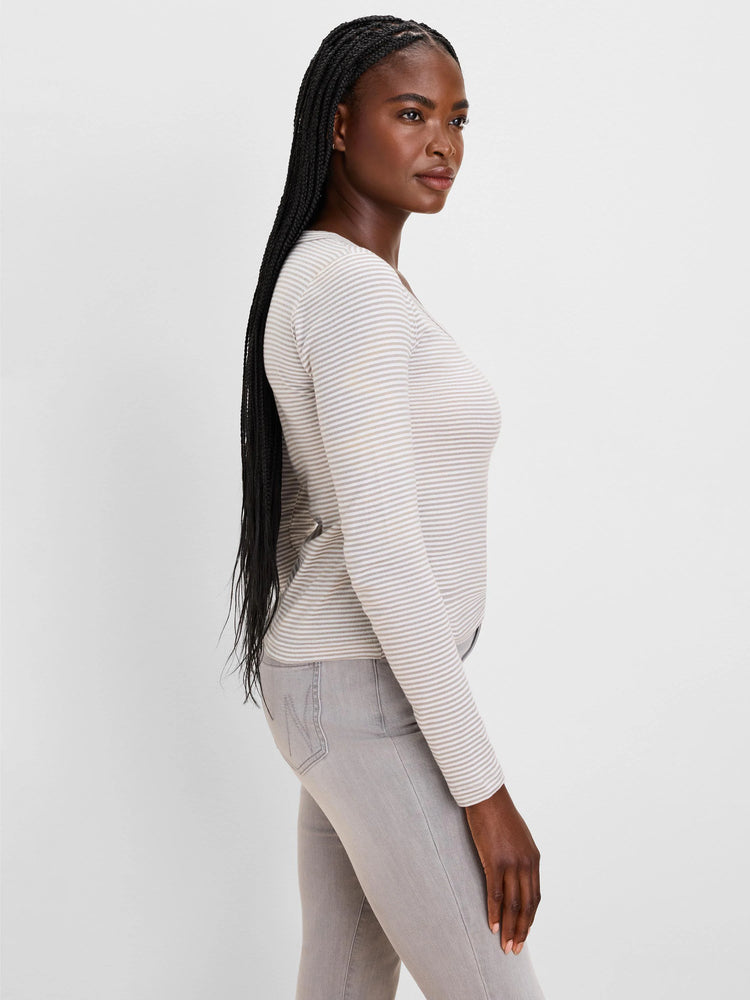 Fitted long sleeve tee with thin horizontal oatmeal and white stripes.