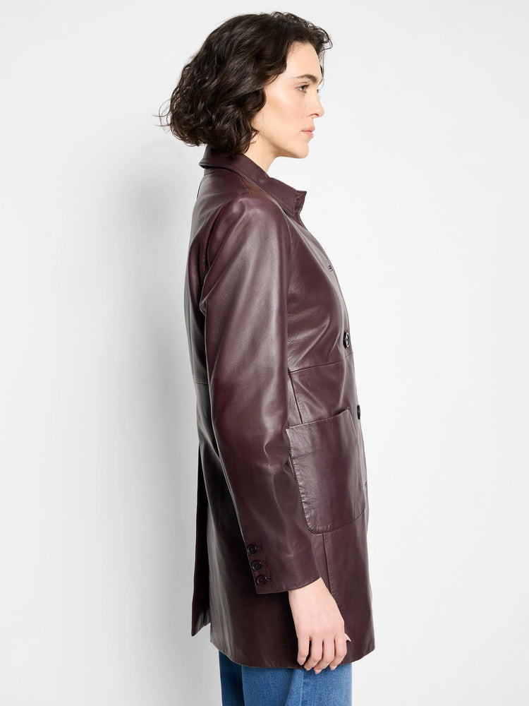Deep burgundy leather car coat, double-breasted, with patch pockets and button cuffs.