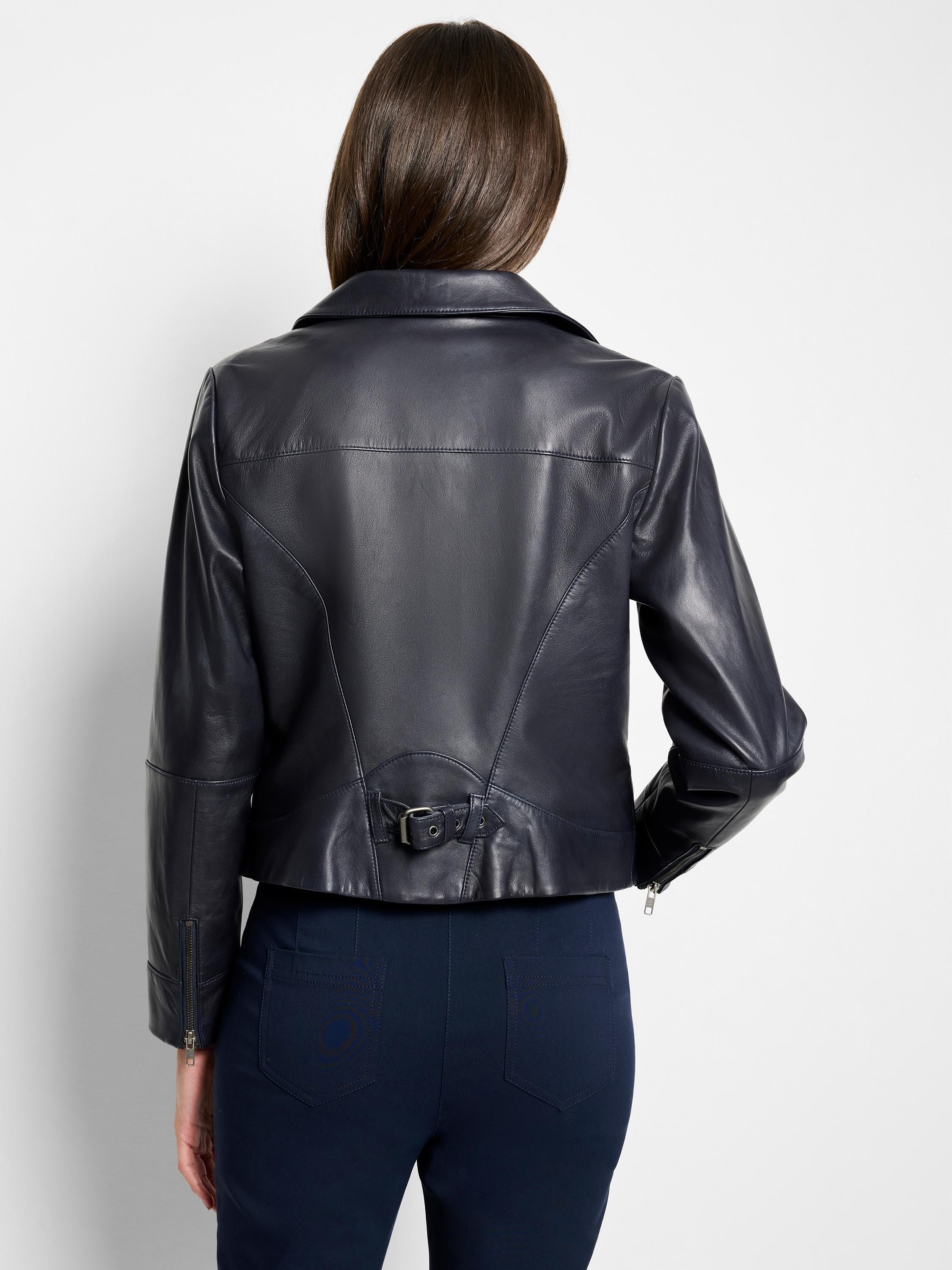 Dark navy blue leather biker jacket, rear view.  Features a belted waist and zippered cuffs.