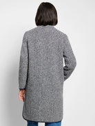 Herringbone pattern topcoat, navy and white.  Long sleeves, hip-length. Dark trim at hem and cuffs.